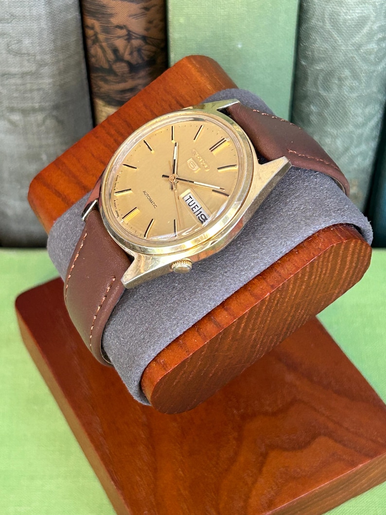 1980's era vintage Seiko automatic watch with gold dial and gold plated case.  Gold plated crown. New brown leather band. Running, serviced, keeps time, working