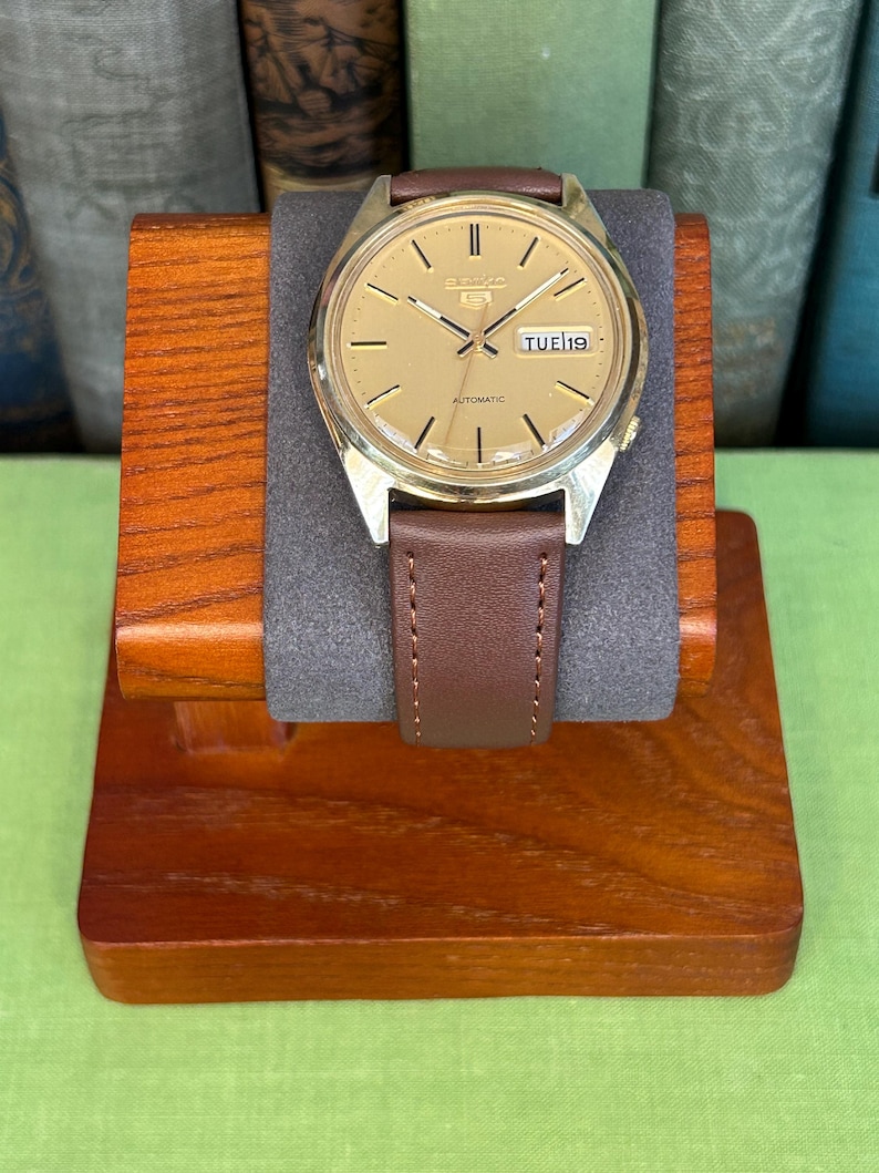1980's era vintage Seiko automatic watch with gold dial and gold plated case.  Gold plated crown. New brown leather band. Running, serviced, keeps time, working