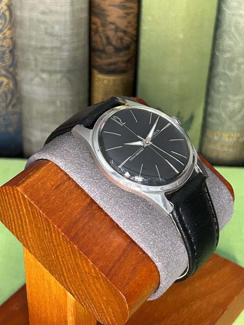 Vintage Benrus watch with black dial and stainless steel case.  Silver crown. New black leather band. Running, serviced, keeps time, working
