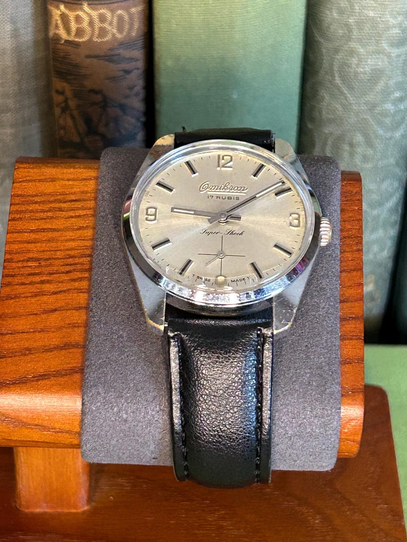 Vintage watch Omikron swiss watch with silver case and small seconds dial.  black leather band and silver crown. Running, serviced, keeps time, working.