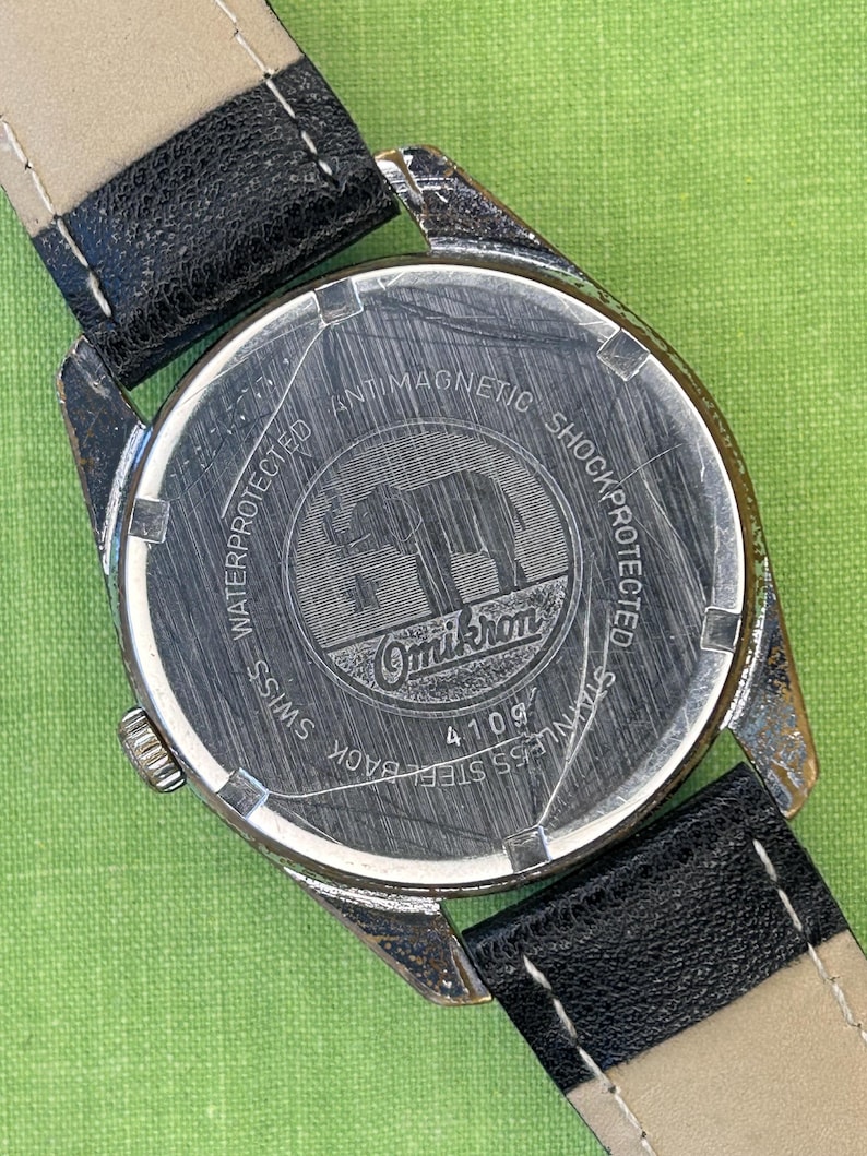 Vintage watch Omikron swiss watch with silver case and small seconds dial.  black leather band and silver crown. Running, serviced, keeps time, working.