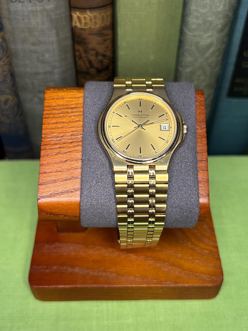 Hamilton Masterpiece Quartz watch model 9162a with gold plated case and original bracelet. Date window.  Running, keeping time, fresh battery.