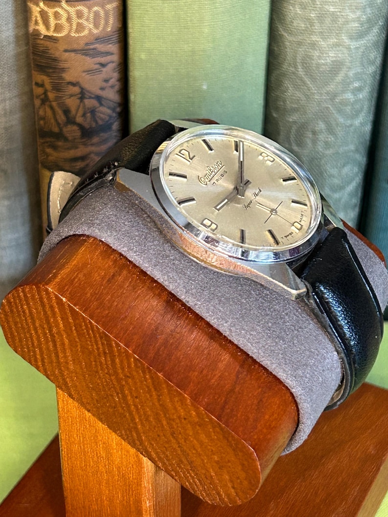 Vintage watch Omikron swiss watch with silver case and small seconds dial.  black leather band and silver crown. Running, serviced, keeps time, working.