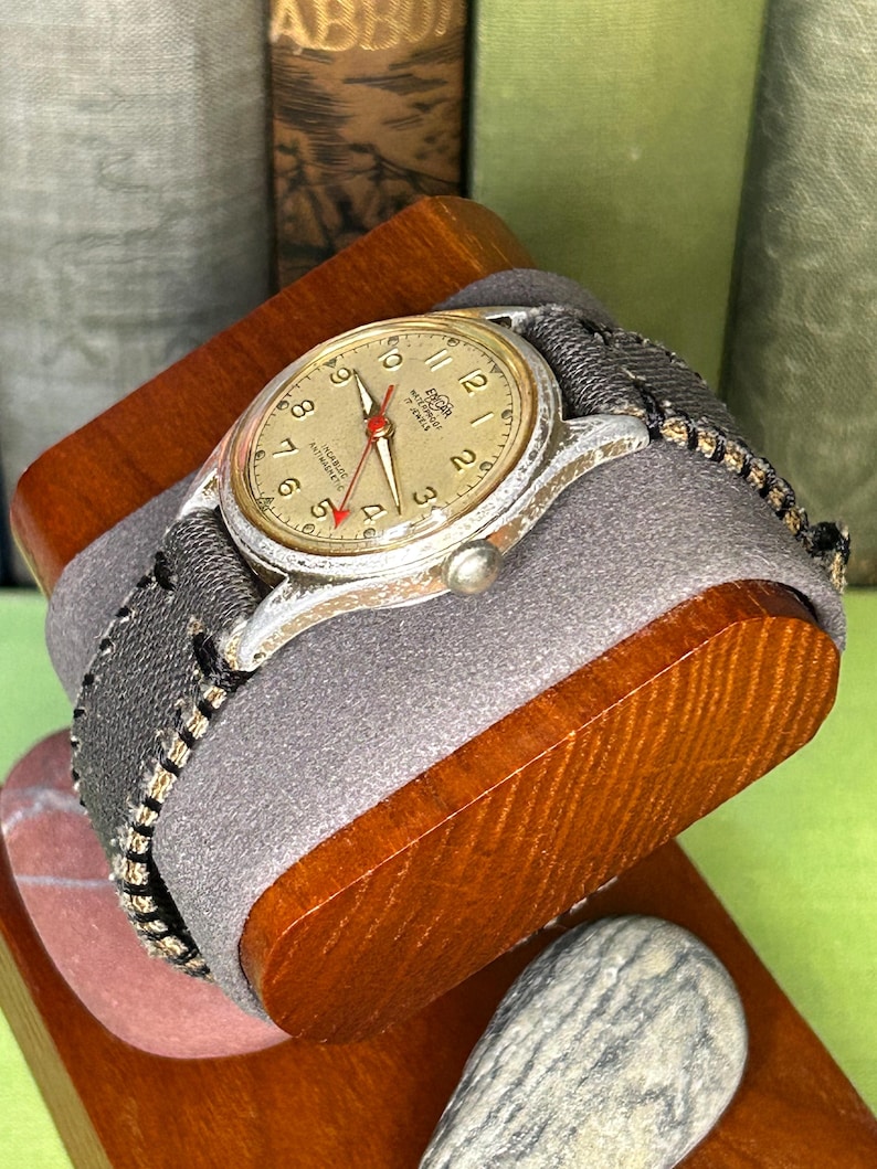 Vintage 1950s Enicar swiss watch with aluminum plated case and red sweep seconds dial. New grey canvas band. Running, serviced, keeps time, working.