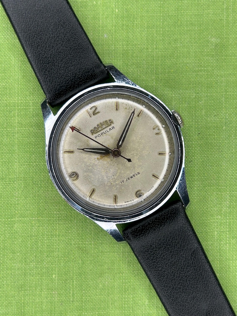 Vintage Roamer Popular watch.  black leather band.  Running, serviced working, keeping time.    Silver color case.