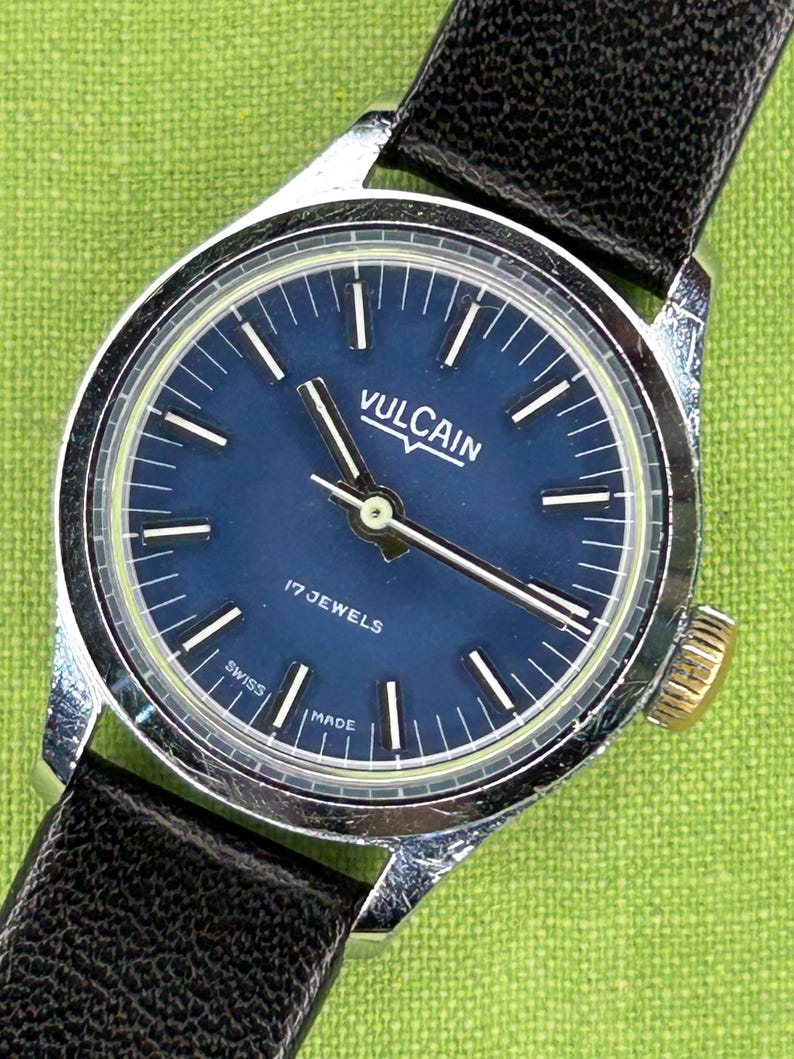 Vintage Vulcain Lady's watch with silver color case and black leather strap.  Serviced and running.  Keeps time. Working. Blue Dial