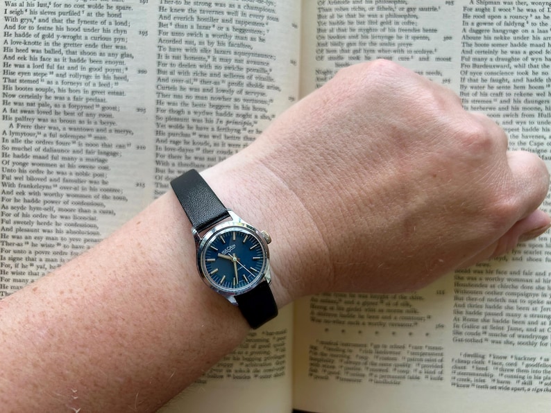 Vintage Vulcain Lady's watch with silver color case and black leather strap.  Serviced and running.  Keeps time. Working. Blue Dial