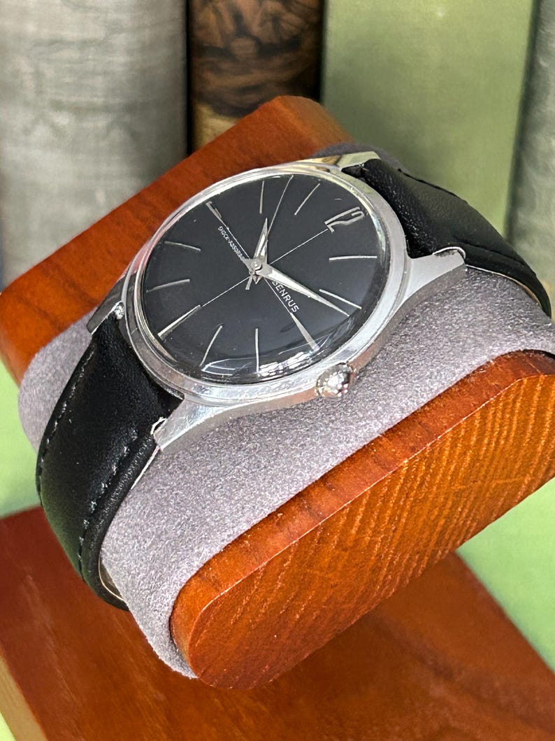 Vintage Benrus watch with black dial and stainless steel case.  Silver crown. New black leather band. Running, serviced, keeps time, working