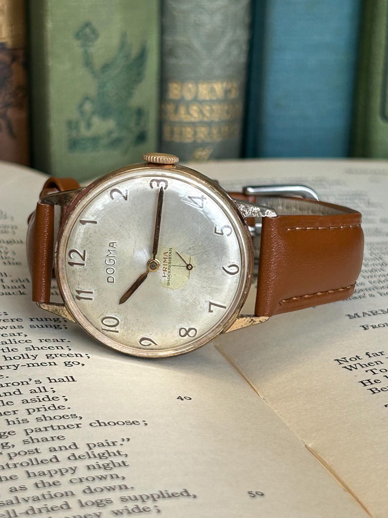 Vintage watch Dogma Prima jumbo swiss watch with rose gold plated case and small seconds dial.  New brown leather band. Running, serviced, keeps time, working.