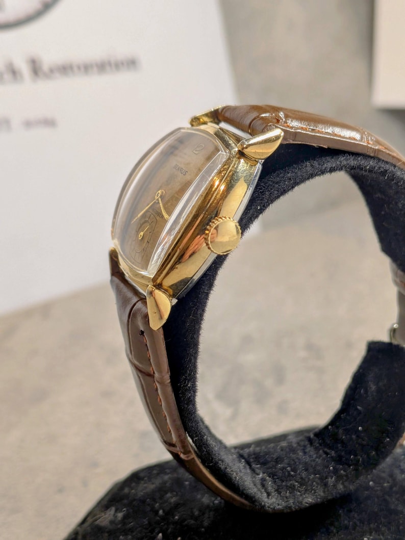 Benrus swiss tank watch with gold plated case and patina dial. New brown leather band. Running, serviced, keeps time, working