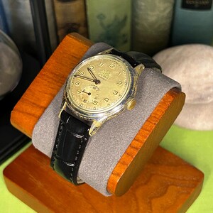 1950s era Fortis swiss watch with chrome plated case and copper colored hands, patina dial. New black leather band. Running, serviced, keeps time, working