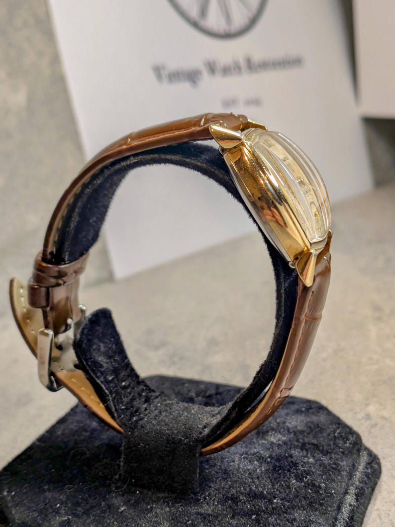 Benrus swiss tank watch with gold plated case and patina dial. New brown leather band. Running, serviced, keeps time, working