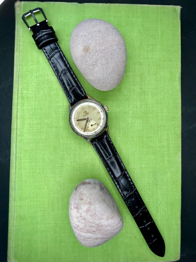 1950s era Fortis swiss watch with chrome plated case and copper colored hands, patina dial. New black leather band. Running, serviced, keeps time, working