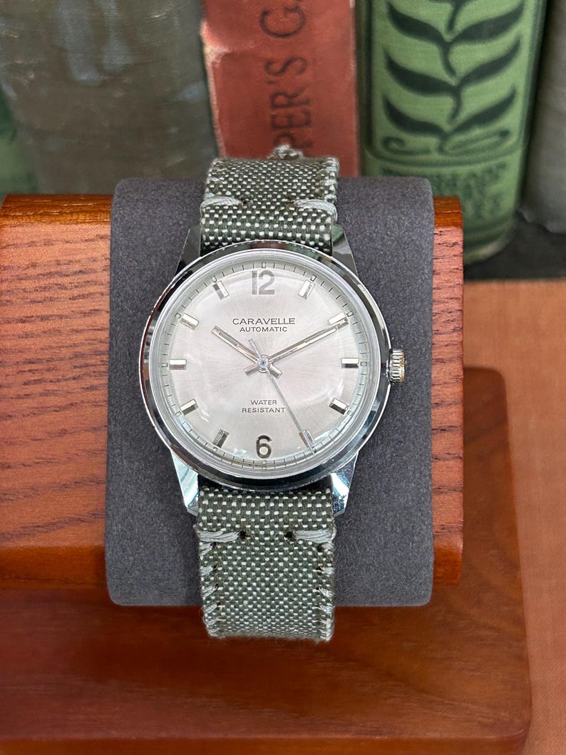 Vintage watch - Caravelle (by Bulova) automatic winding watch with green canvas strap.  swiss movement.  Serviced, running and keeping time.