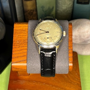 1950s era Fortis swiss watch with chrome plated case and copper colored hands, patina dial. New black leather band. Running, serviced, keeps time, working