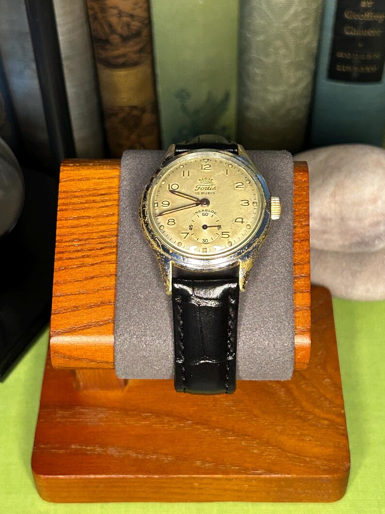 1950s era Fortis swiss watch with chrome plated case and copper colored hands, patina dial. New black leather band. Running, serviced, keeps time, working