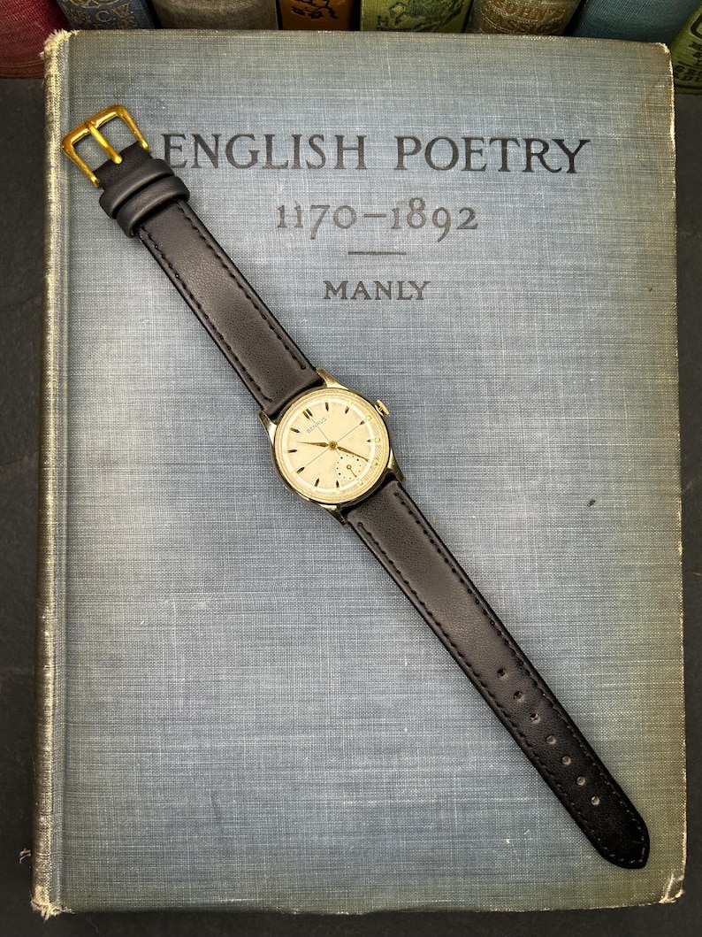 1950s Vintage Benrus crosshair watch with waffle dial and round gold plated case.  Gold crown. New black leather band. Running, serviced, keeps time, working