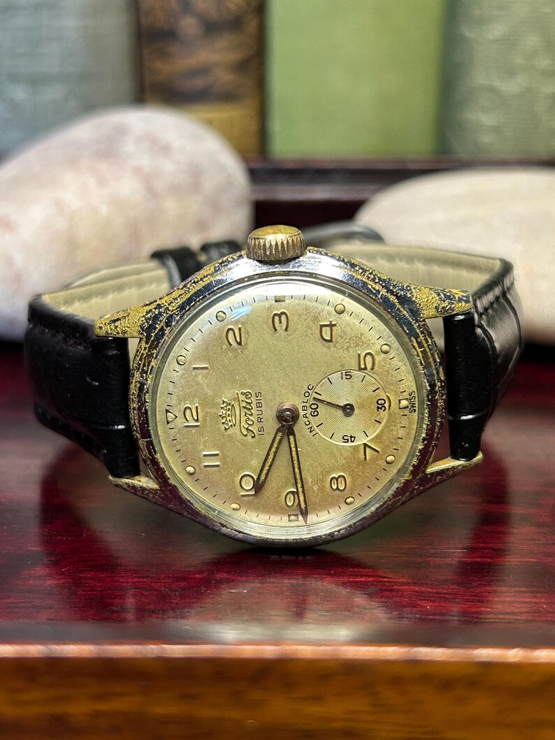 1950s era Fortis swiss watch with chrome plated case and copper colored hands, patina dial. New black leather band. Running, serviced, keeps time, working