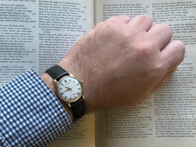 1950s Vintage Benrus crosshair watch with waffle dial and round gold plated case.  Gold crown. New black leather band. Running, serviced, keeps time, working