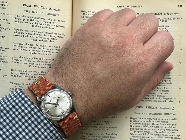 Vintage watch Dogma swiss watch with silver case and sweep seconds dial.  Has date window. New custom orange band and silver crown. Running, serviced, keeps time, working.