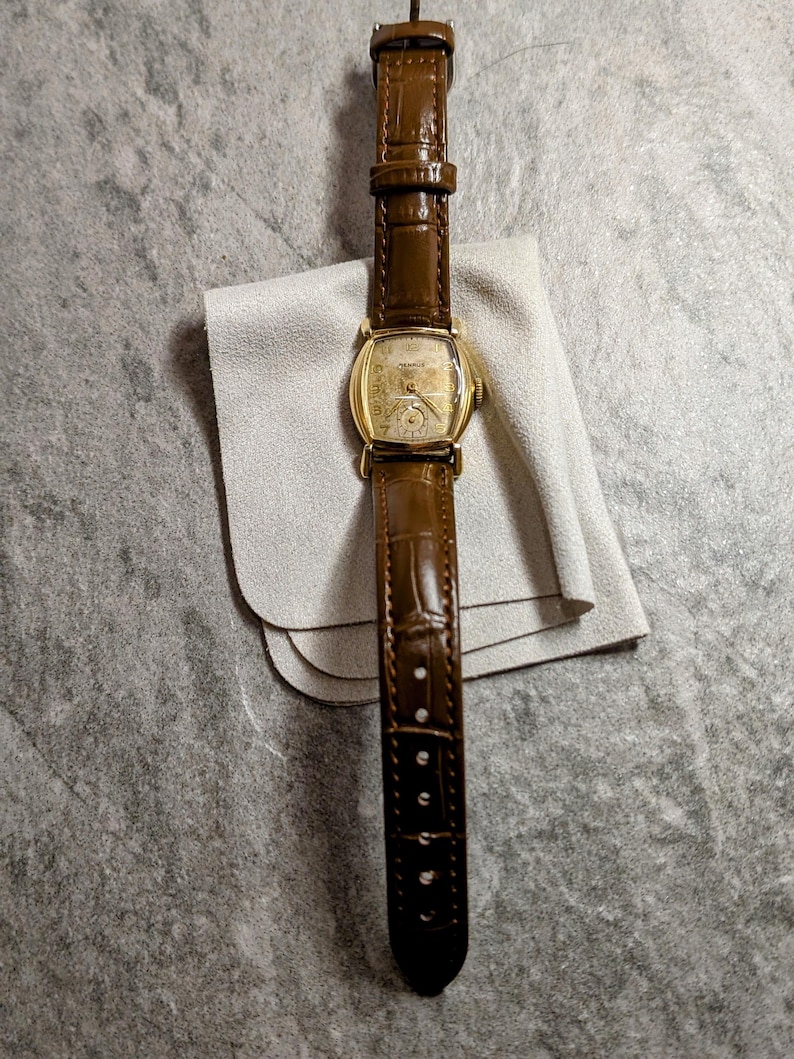 Benrus swiss tank watch with gold plated case and patina dial. New brown leather band. Running, serviced, keeps time, working