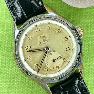 1950s era Fortis swiss watch with chrome plated case and copper colored hands, patina dial. New black leather band. Running, serviced, keeps time, working