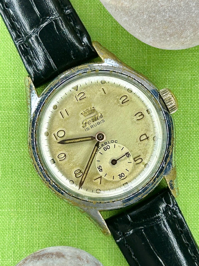 1950s era Fortis swiss watch with chrome plated case and copper colored hands, patina dial. New black leather band. Running, serviced, keeps time, working