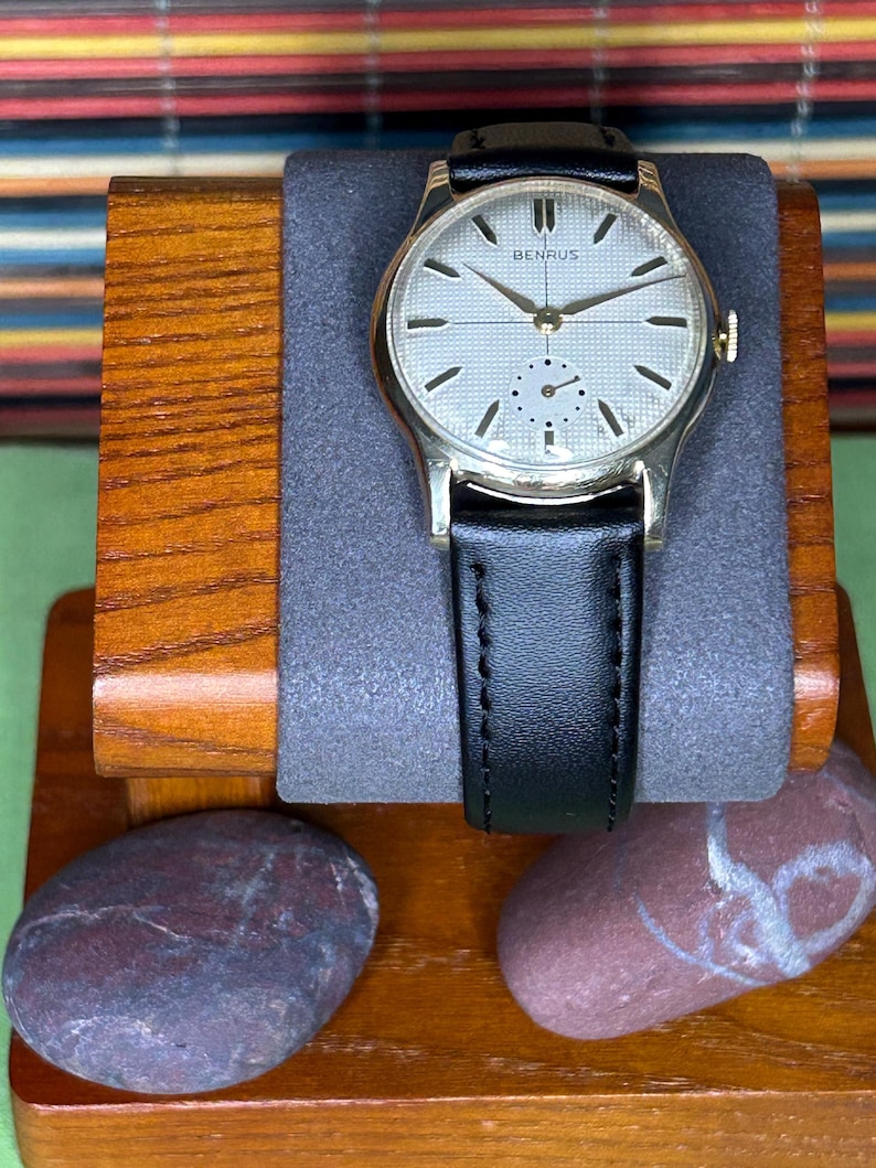 1950s Vintage Benrus crosshair watch with waffle dial and round gold plated case.  Gold crown. New black leather band. Running, serviced, keeps time, working