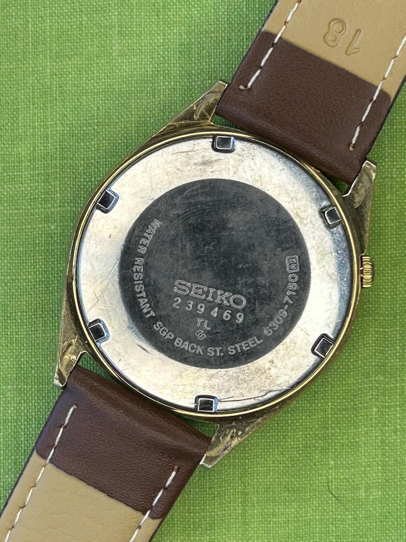 1980's era vintage Seiko automatic watch with gold dial and gold plated case.  Gold plated crown. New brown leather band. Running, serviced, keeps time, working
