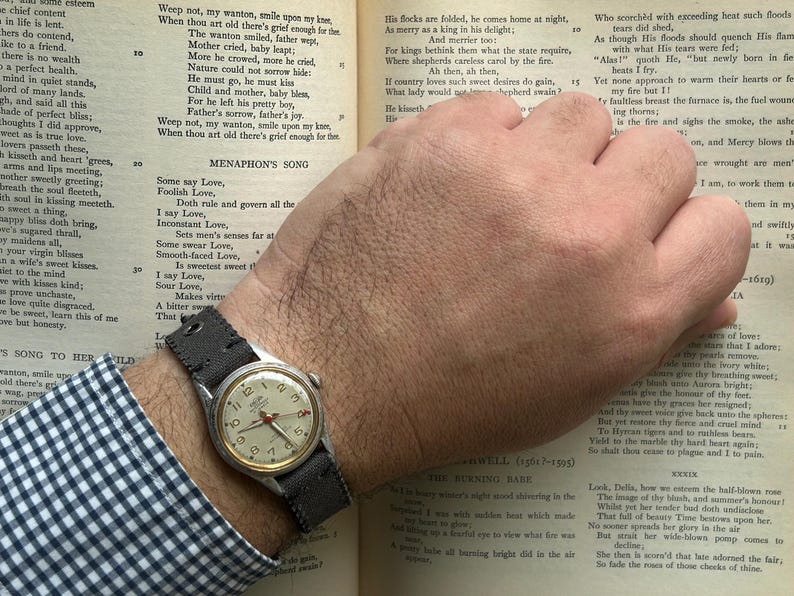 Vintage 1950s Enicar swiss watch with aluminum plated case and red sweep seconds dial. New grey canvas band. Running, serviced, keeps time, working.