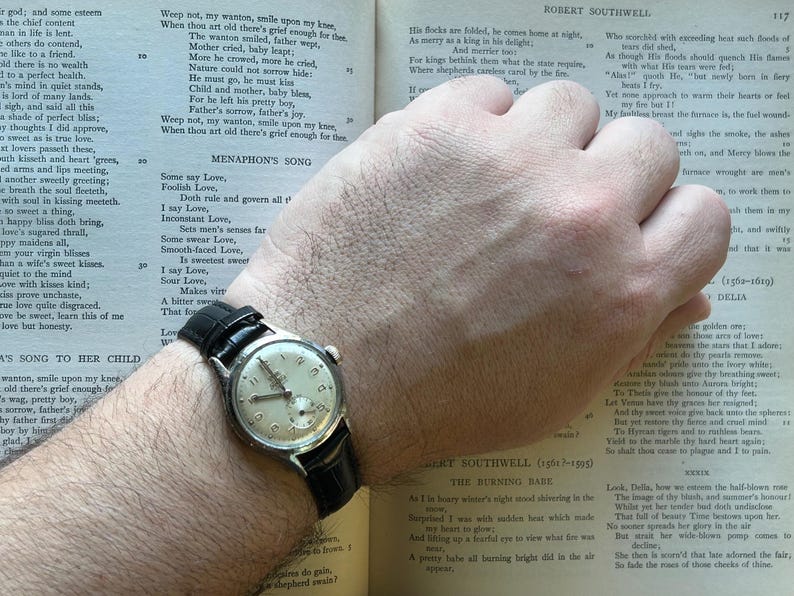 1950s era Fortis swiss watch with chrome plated case and copper colored hands, patina dial. New black leather band. Running, serviced, keeps time, working