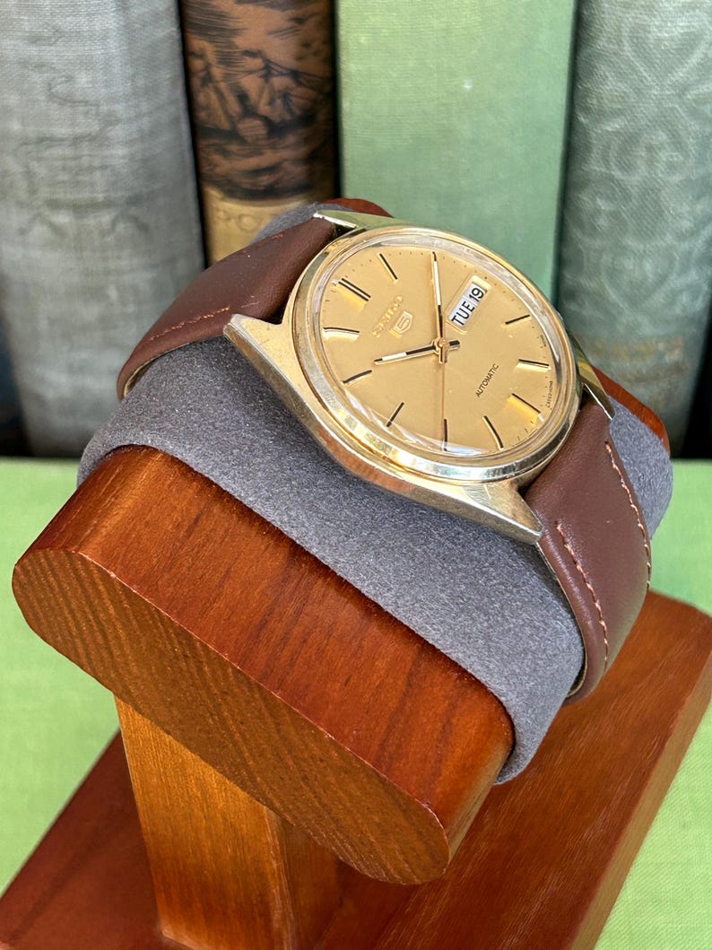 1980's era vintage Seiko automatic watch with gold dial and gold plated case.  Gold plated crown. New brown leather band. Running, serviced, keeps time, working