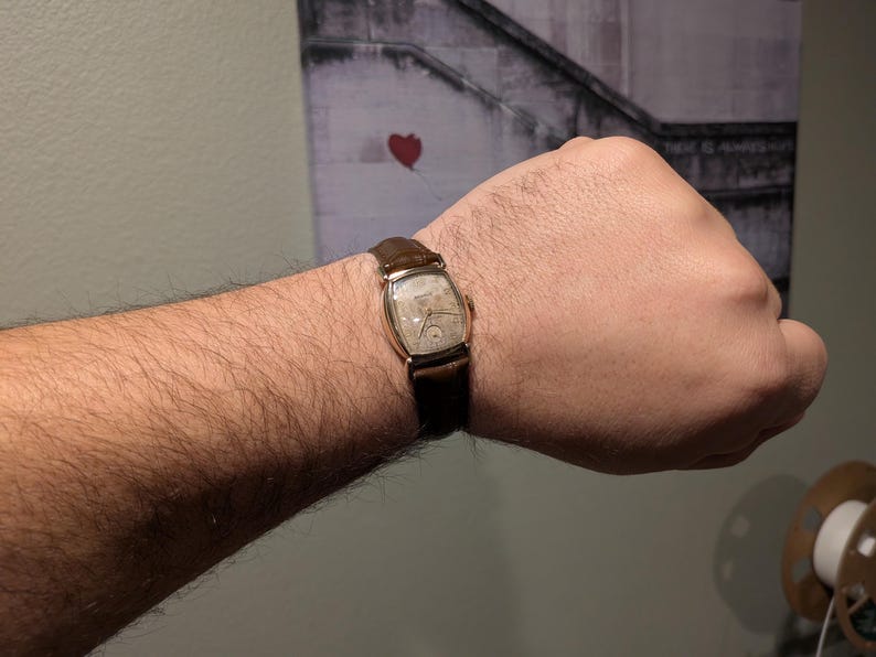 Benrus swiss tank watch with gold plated case and patina dial. New brown leather band. Running, serviced, keeps time, working