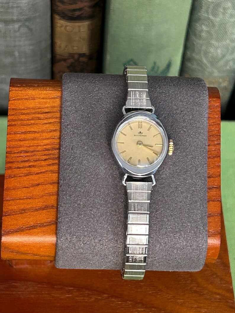 1970's Vintage Bucherer Ladies watch with Stainless Steel case and original bracelet.  Serviced and running.  Keeps time. works