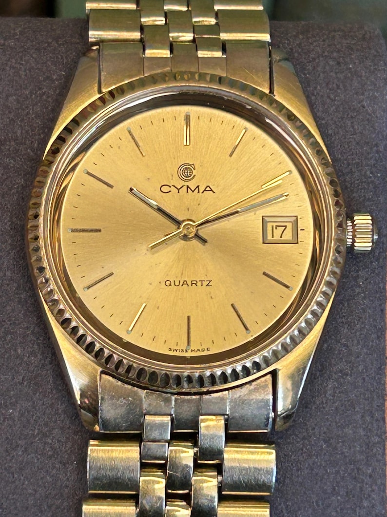 Vintage 1980s Cyma quartz watch with gold plated case and original bracelet. Just Serviced, Running and working great. Fresh battery.