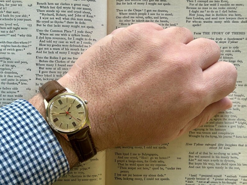 Vintage 1970 Bulova Sea King swiss watch with gold plated case and red sweep seconds dial. New brown leather band. Running, serviced, keeps time, working.