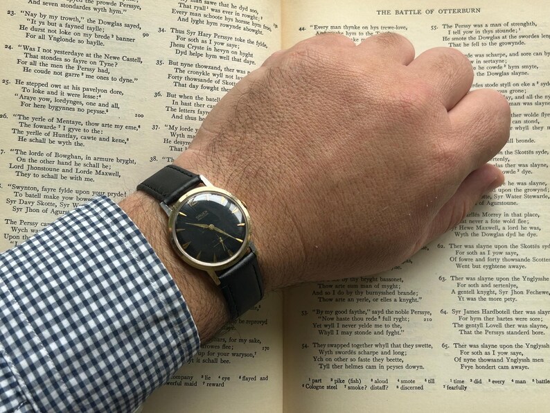 Vintage 1960s Gruen Precision watch.  Black leather band.  Running, serviced, keeps time, working.  Gold plated case with black dial