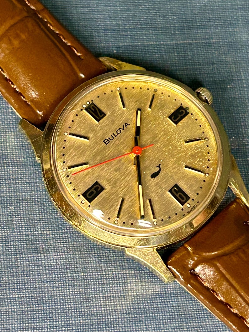 Vintage 1970 Bulova Sea King swiss watch with gold plated case and red sweep seconds dial. New brown leather band. Running, serviced, keeps time, working.