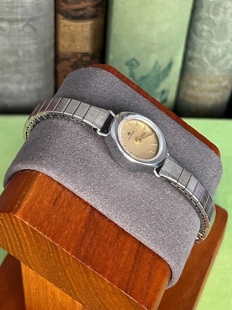 1970's Vintage Bucherer Ladies watch with Stainless Steel case and original bracelet.  Serviced and running.  Keeps time. works