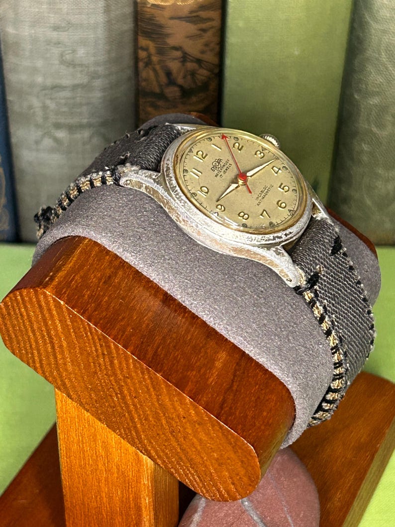 Vintage 1950s Enicar swiss watch with aluminum plated case and red sweep seconds dial. New grey canvas band. Running, serviced, keeps time, working.
