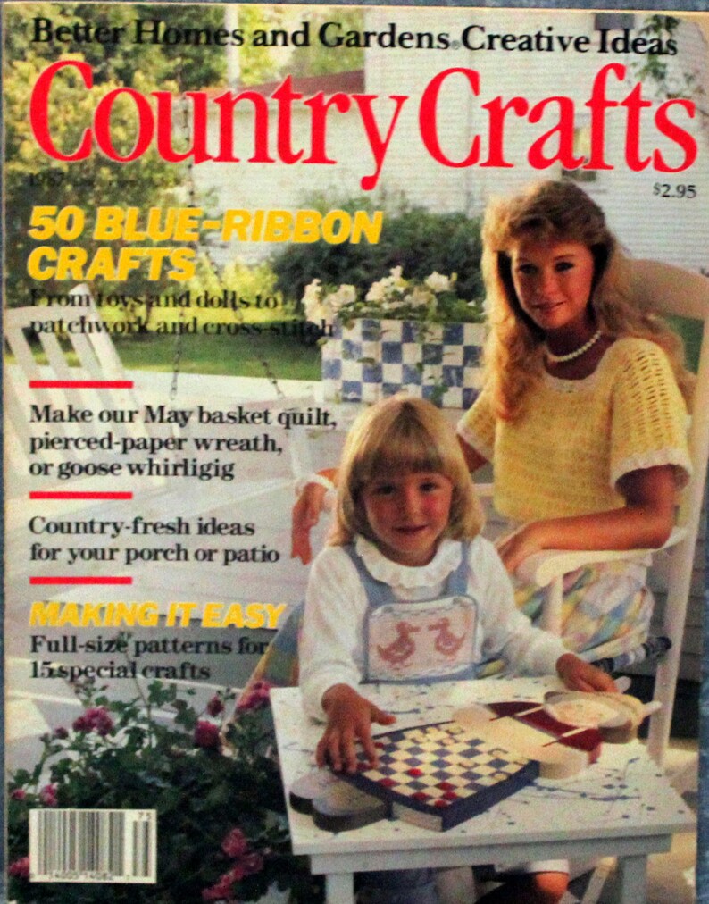 May include: A magazine cover for Country Crafts featuring a girl playing a checkerboard game on a white table. The magazine cover has a yellow title and the text "50 Blue-Ribbon Crafts" in yellow. The text "Making It Easy" is in red. The magazine cover also features a woman sitting in a white chair with a yellow and white crocheted top.