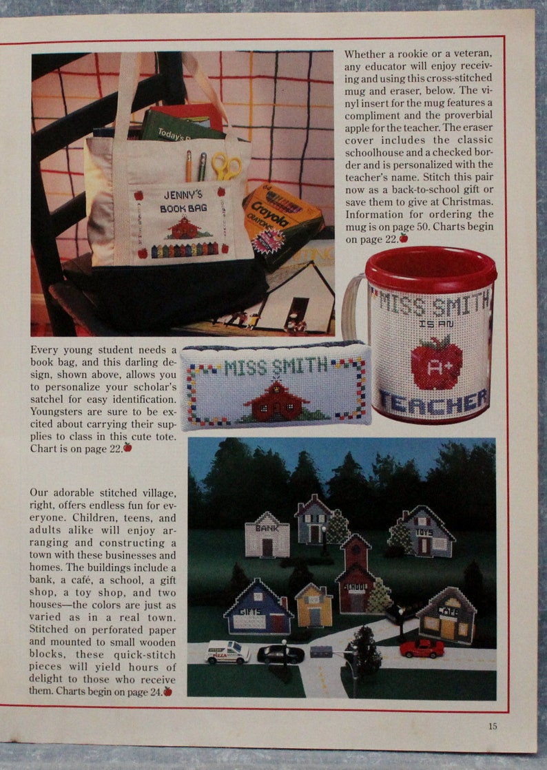 May include: Image of cross-stitch designs. It shows a tote bag with "Jenny's Book Bag", a mug with "Miss Smith is an A+ Teacher", and a stitched village with buildings like a bank and school.