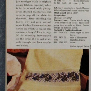 May include: A yellow hand towel with a cross-stitched blueberry design. The towel is displayed with a rolling pin and the text "Coffee Break". The design size is 14-count 35.56cm x 23.5cm.