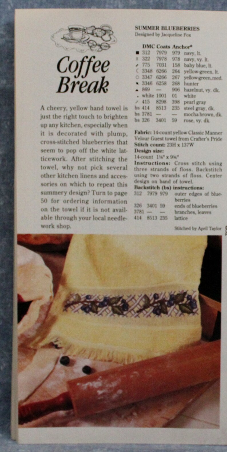 May include: A yellow hand towel with a cross-stitched blueberry design. The towel is displayed with a rolling pin and the text "Coffee Break". The design size is 14-count 35.56cm x 23.5cm.