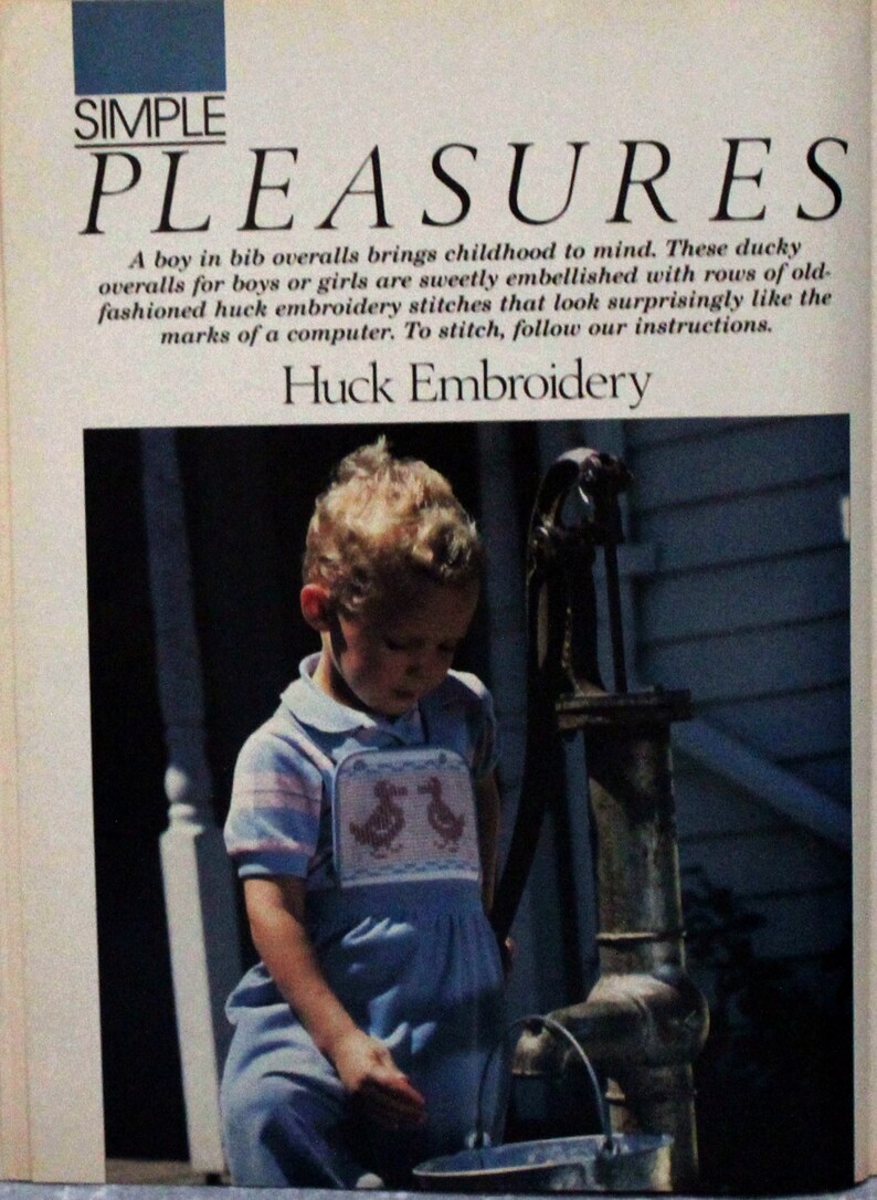 May include: A young child wearing blue overalls with a pink and white duck embroidery design stands by a hand pump. The overalls have a bib with two ducks embroidered on it. The child is looking down at the pump handle. The text "SIMPLE PLEASURES" is at the top of the image. The text "Huck Embroidery" is below the image.