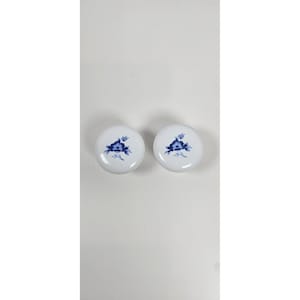 May include: A white ceramic mug with a black handle and the text "But First, Coffee" in a black, handwritten-style font. The mug is on a white surface.