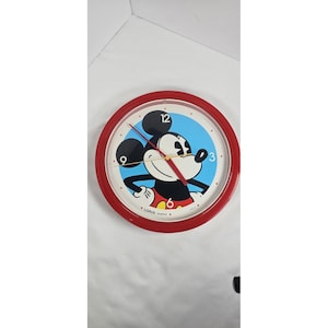 May include: A white ceramic mug with a black handle and the text "But First, Coffee" in a black, handwritten-style font. The mug is on a white surface.