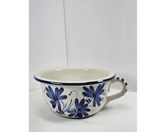 Bol de sopa de cerámica azul vintage con asa y estampado floral, ideal para servir en la cocina rústica.