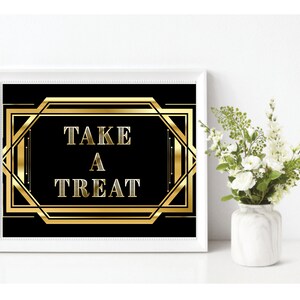 May include: A black and gold sign with an Art Deco design that says "Take a Treat".
