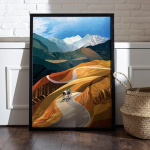 May include: Two cyclists ride up a winding road through a colourful mountain landscape. The road is paved and curves through the hills, which are painted in shades of green, brown, and yellow. The sky is blue with white clouds.